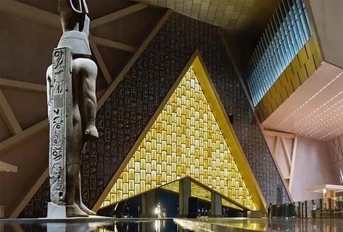 a view to the back of the statue of Ramses II from the inside the Grand Egyptian Museum